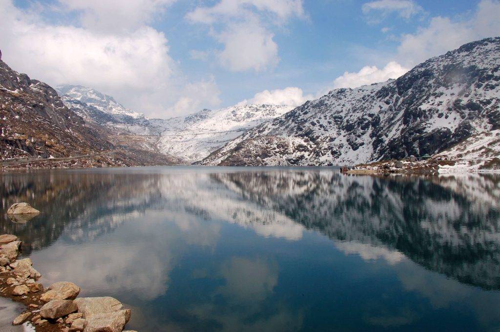 Reflection of snowy mountains on the clear waters of Changu Lake