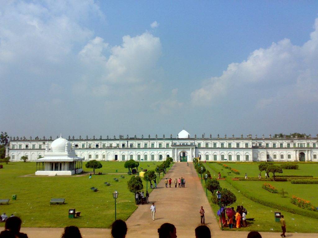 White colored Murshidabad Imambara and surrounding gardens under clear blue sky