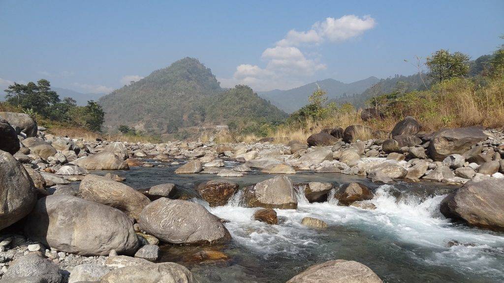 Murti river flowing through the valley surrounded by hills