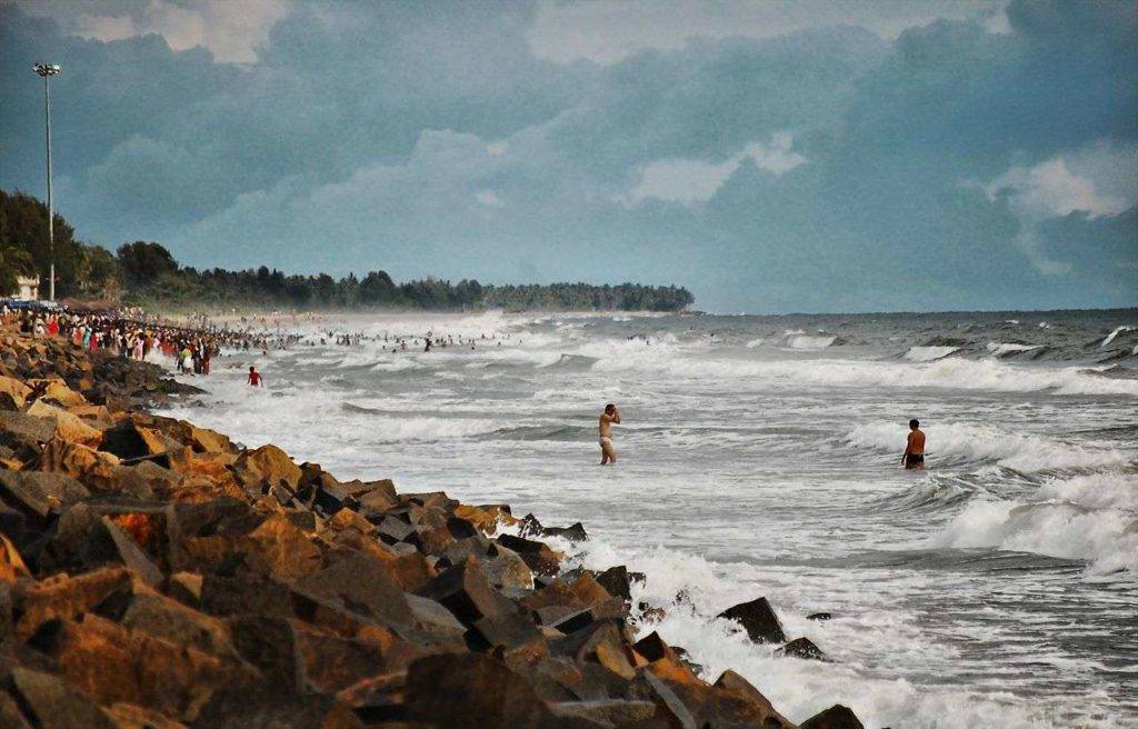 People bathing in the rough waters of Cherai beach near Kochi