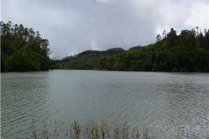 Calm waters of Berijam Lake under a cloudy sky