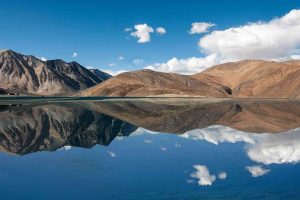 Reflection of mountains on the still clear waters of Pangong Lake