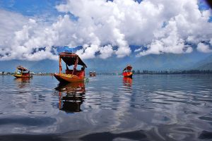 Shikara Ride on Dal Lake with white clouds floating on the blue sky