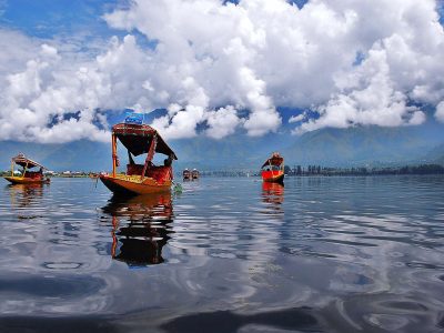 Shikara Ride on Dal Lake with white clouds floating on the blue sky